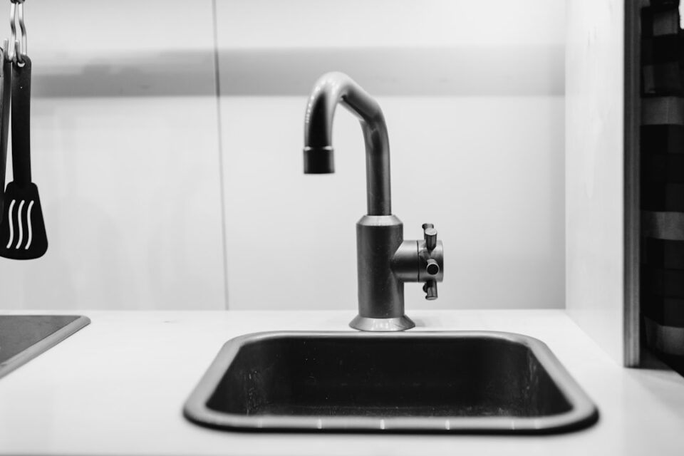 Kitchen Sink Drain Cleaning tools beside a slow-draining sink